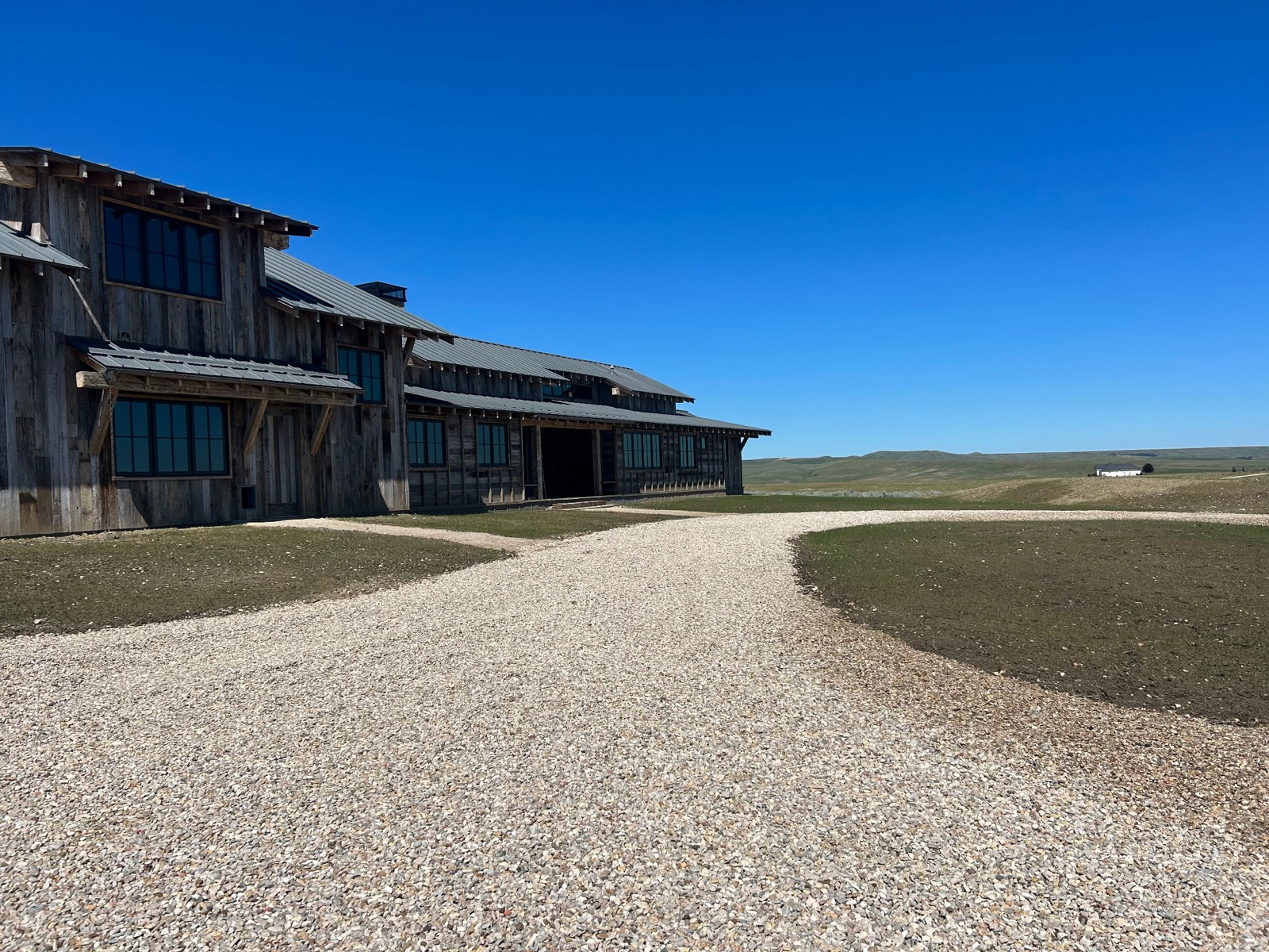 Dayton residential before — gravel driveway and bare landscape around lodge
