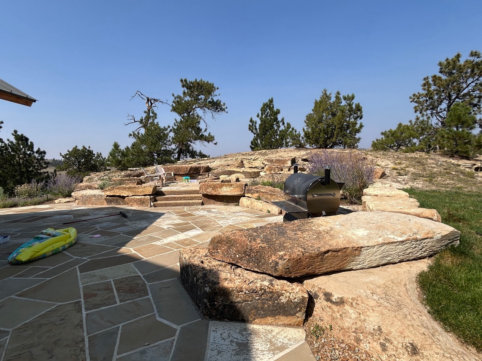 Quarter Circle 7 Ranch — flagstone patio with boulders and tiered landscaping