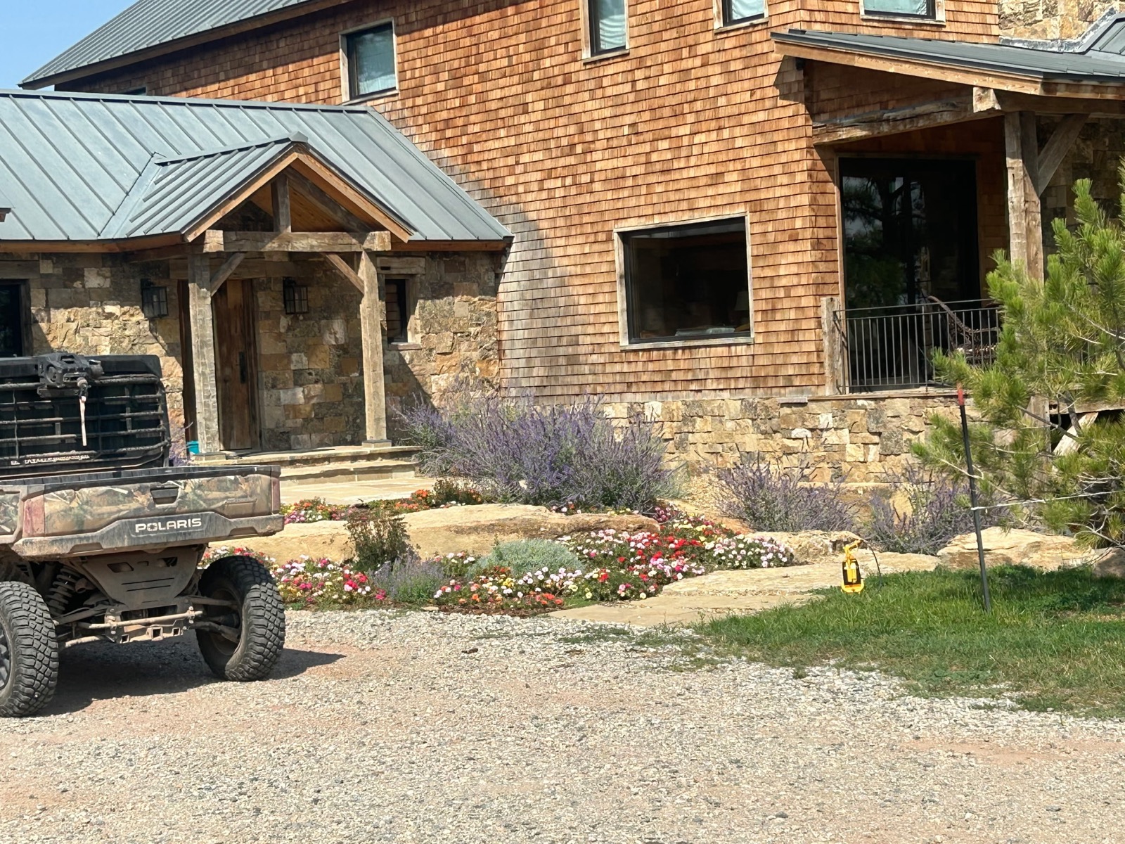 Quarter Circle 7 Ranch — front entry with flower beds and native plantings